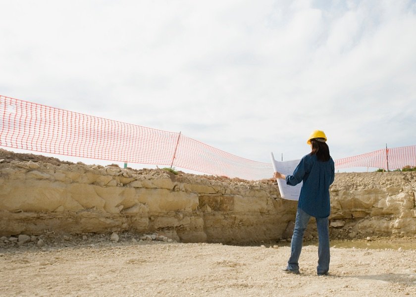 construction worker looking at blueprints